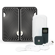 The TENS Comfee square is black in colour and is sitting in front of its plastic storage box. The accessories sitting in front of the TENS machine are the 2 electrode pads and a charging cable. The TENS Comfee Power square also has a remote that is upright and sitting to the right of the device. Behind the TENS machine is a large black and white footpad. The background is white.