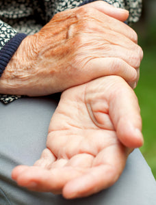 lady holding her hands in pain with arthritis. 