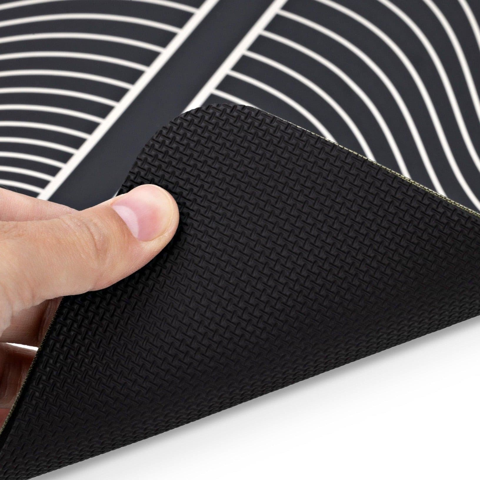 TENS Comfee Foot Pad. Black and white striped for TENS machine. Pad only in photo with hand showing the non slip matting surface underneath.