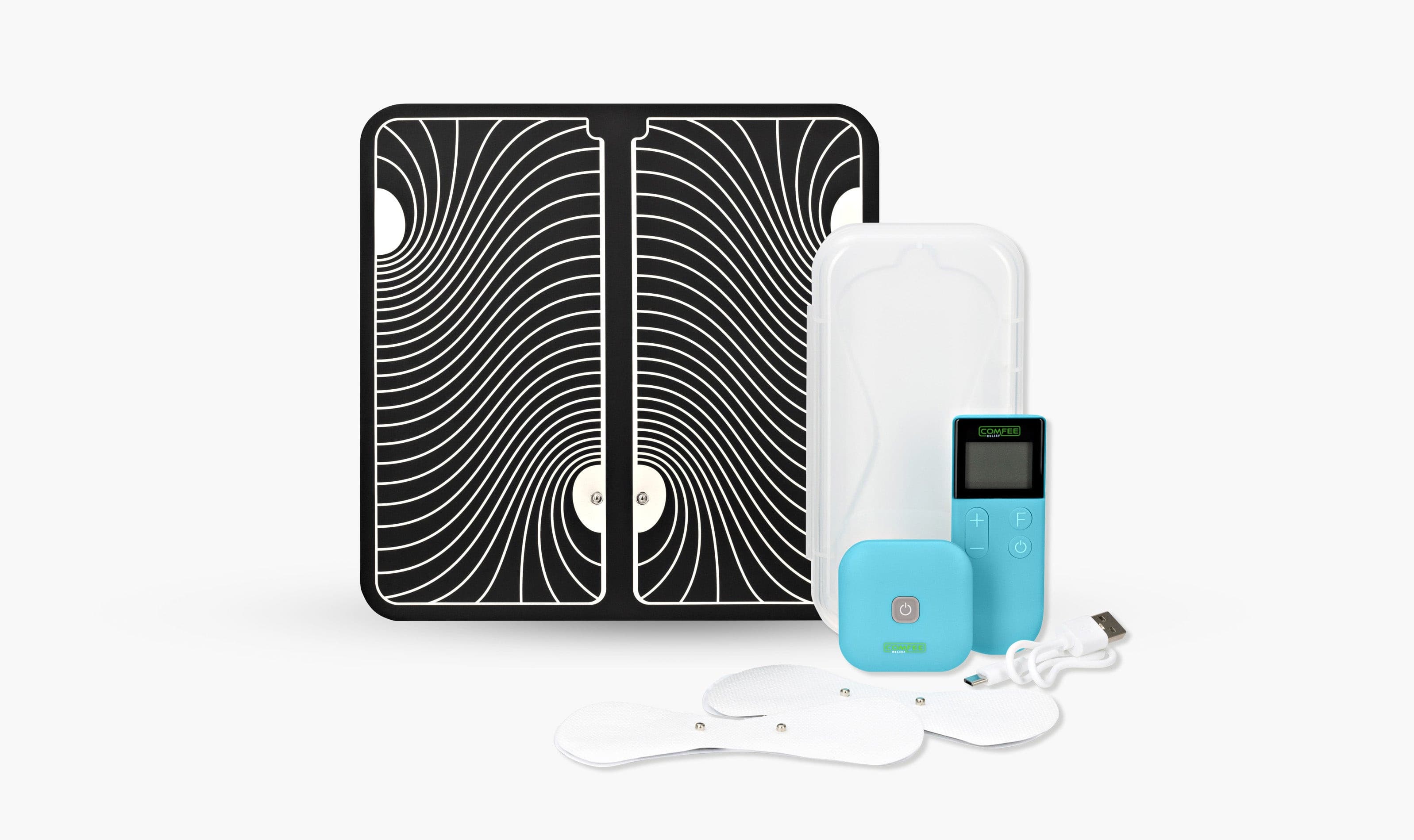 The TENS Comfee square is blue in colour and is sitting in front of its plastic storage box. The accessories sitting in front of the TENS machine are the 2 electrode pads and a charging cable. The TENS Comfee Power square also has a remote that is upright and sitting to the right of the device. Behind the TENS machine is a large black and white footpad. The background is white. 